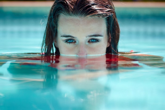Woman with blue eyes in a swimming pool