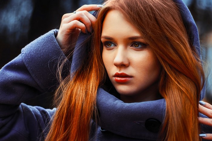 Woman with red hair wearing a blue hood