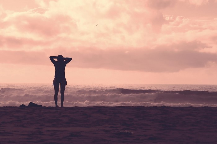 Silhouette of a woman on a beach at sunset
