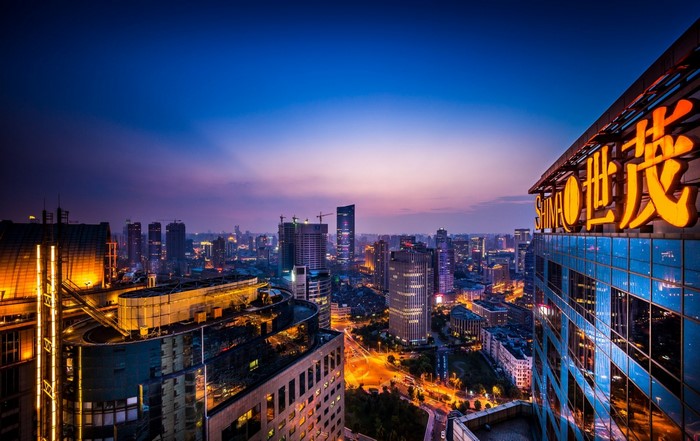 Cityscape at Dusk with Illuminated Skyscrapers and Signage