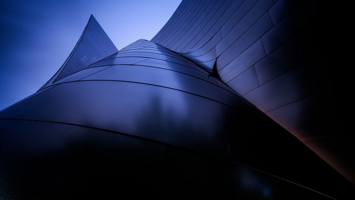 Abstract blue building with curved metallic facade