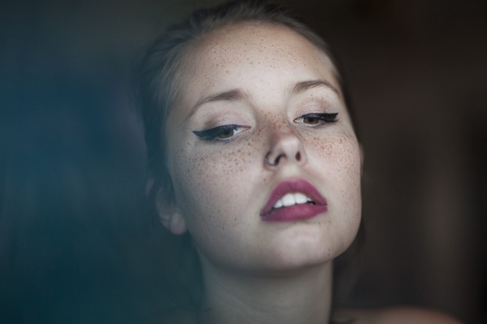 Woman with freckles and winged eyeliner