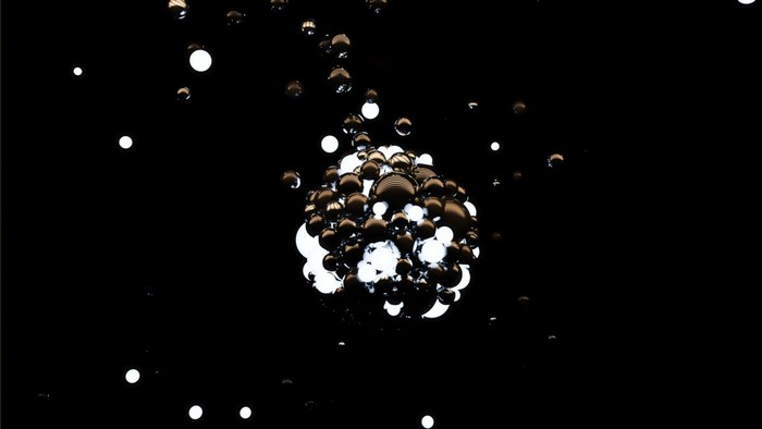 Abstract cluster of glowing spheres in darkness