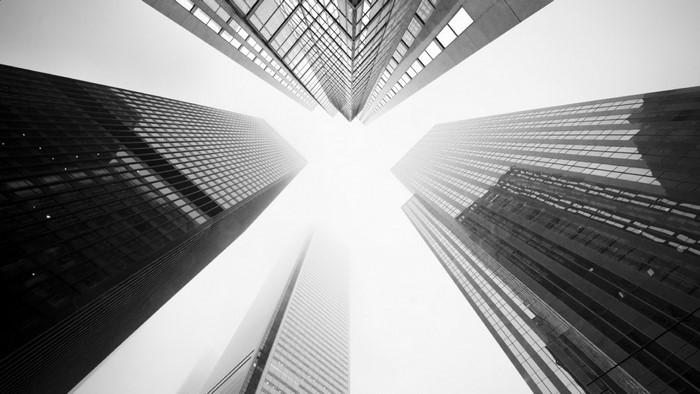 Monochrome low-angle view of skyscrapers in fog