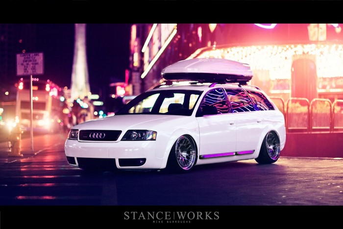 White Audi station wagon with roof box at night