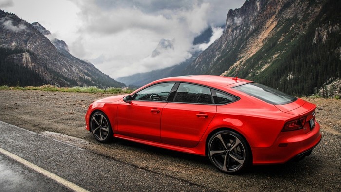 Red Audi RS7 parked on a mountain road