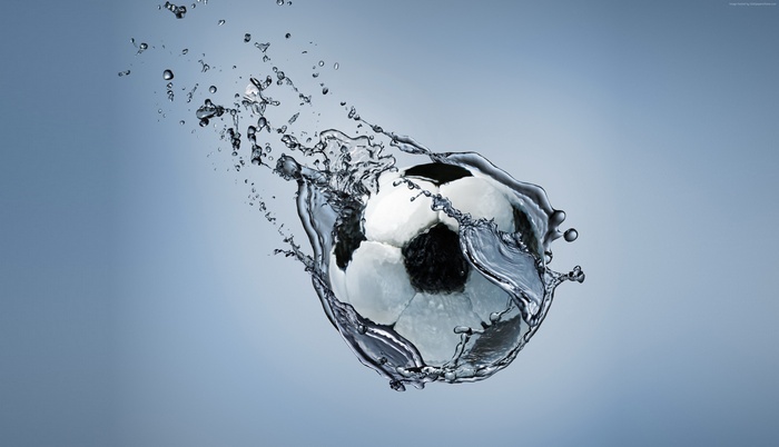 Soccer ball splashing through water