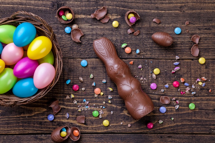 Chocolate Easter bunny and eggs on wooden table