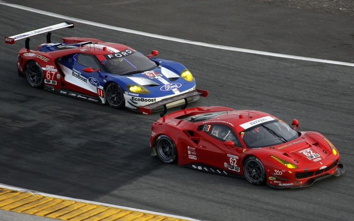 Ford GT and Ferrari race cars on a track