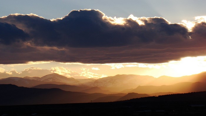Sunset over mountains with dramatic clouds