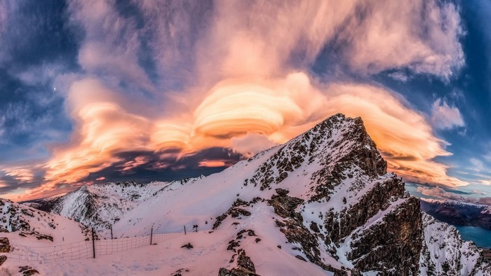Sunset Over Snow-Covered Mountain Summit