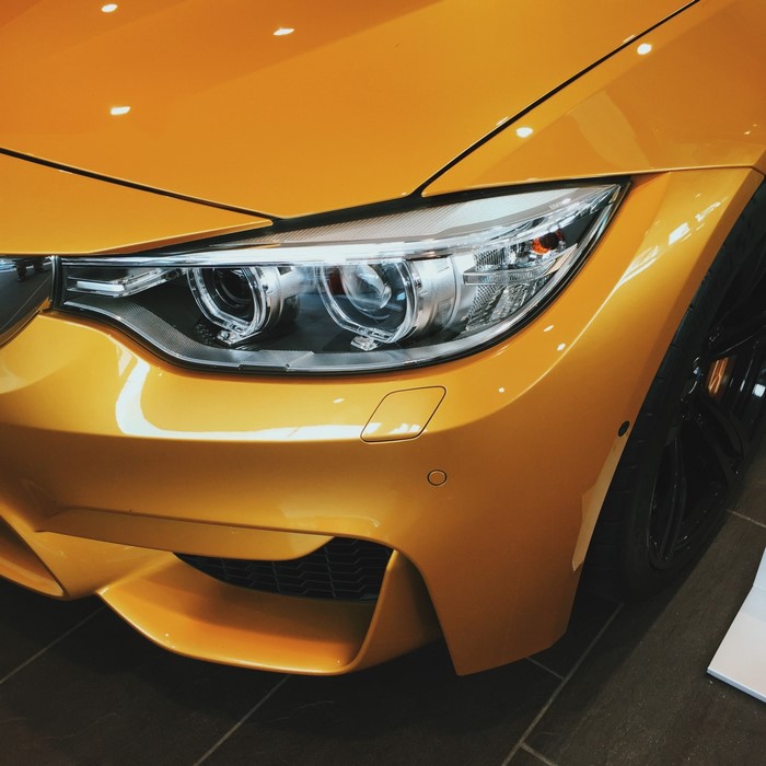 Close-up of a yellow BMW M4 Coupe headlight