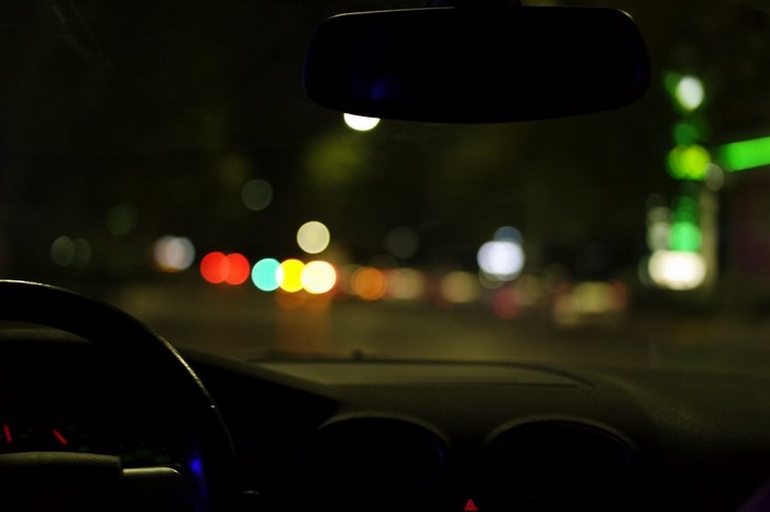 Driving at night with city lights