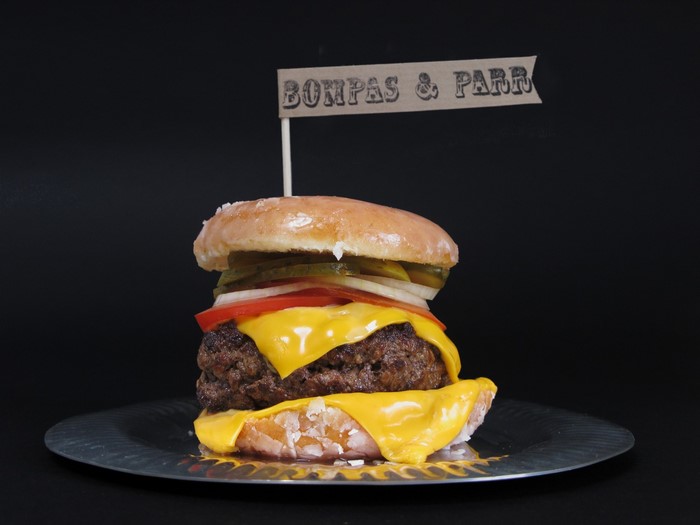 Cheeseburger with donut buns and a flag