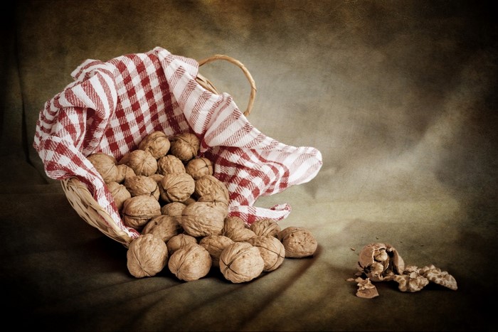 Basket of walnuts with a cracked nut
