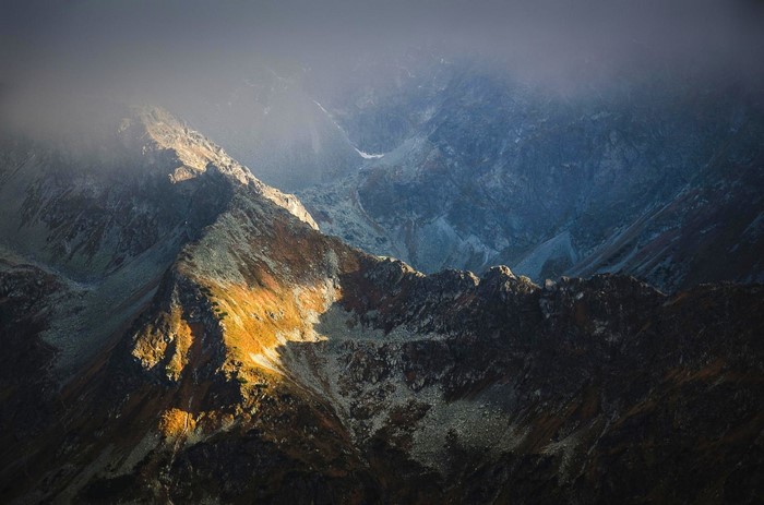 Sunlight on a misty mountain ridge in the Tatra Mountains