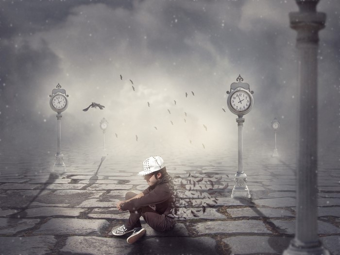 A child sits on a cobblestone path with clocks and birds in the mist
