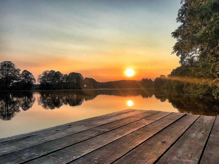 Wooden dock on a lake at sunset