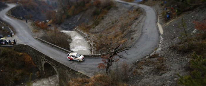 Citroen rally car on a bridge over a river