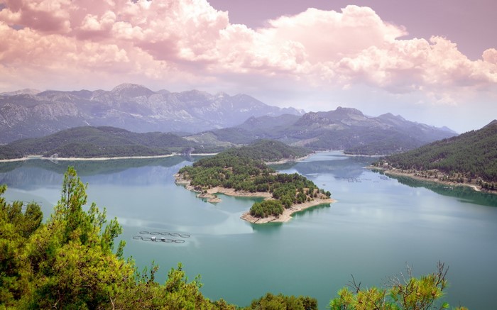 Island peninsula in a mountain lake reservoir