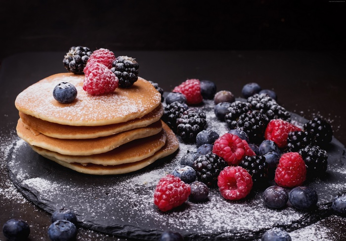 Stack of Pancakes with Mixed Berries and Powdered Sugar