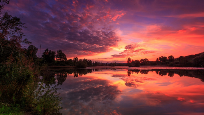 Sunset over a lake with colorful clouds and reflections