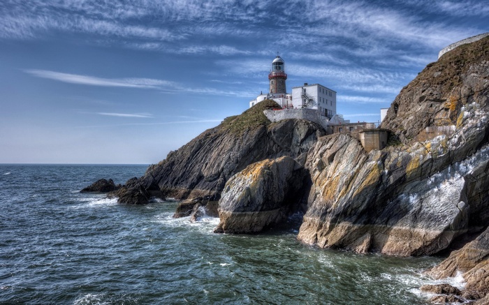 Lighthouse on a rocky cliff overlooking the sea