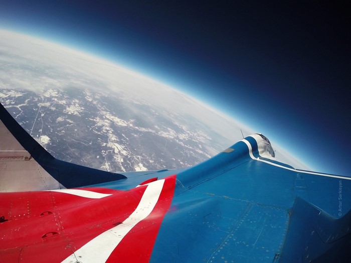 MiG-29 aircraft wing over Earth's atmosphere