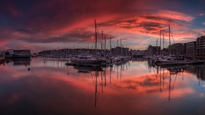 Marina at sunset with colorful clouds and reflections