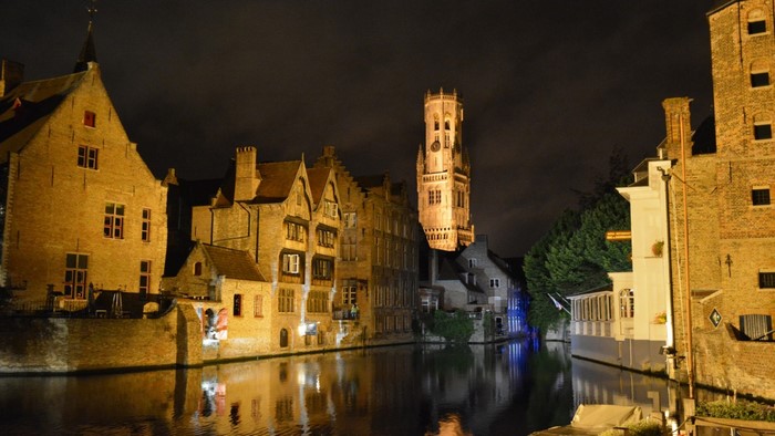 Night cityscape with canal and Belfry tower