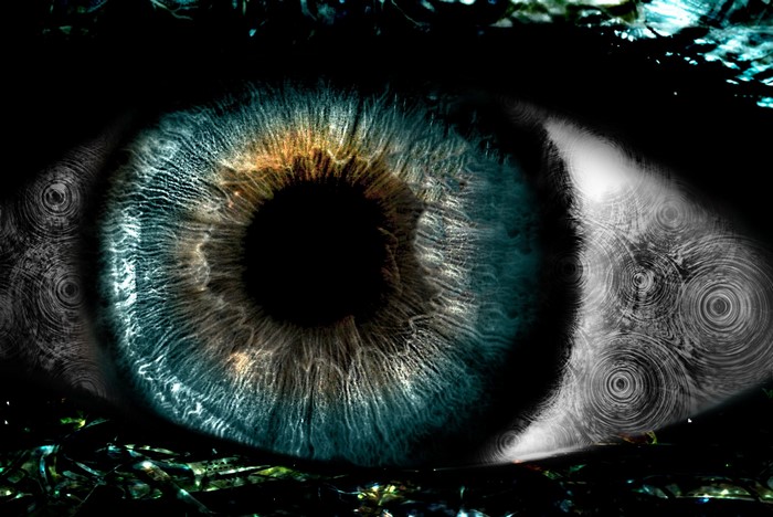 Close-up of a human eye with fractal patterns