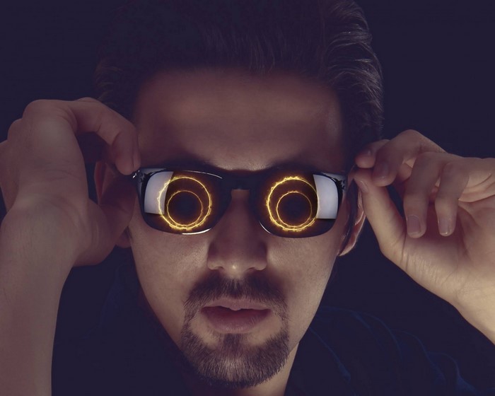 Man wearing sunglasses with glowing rings in lenses