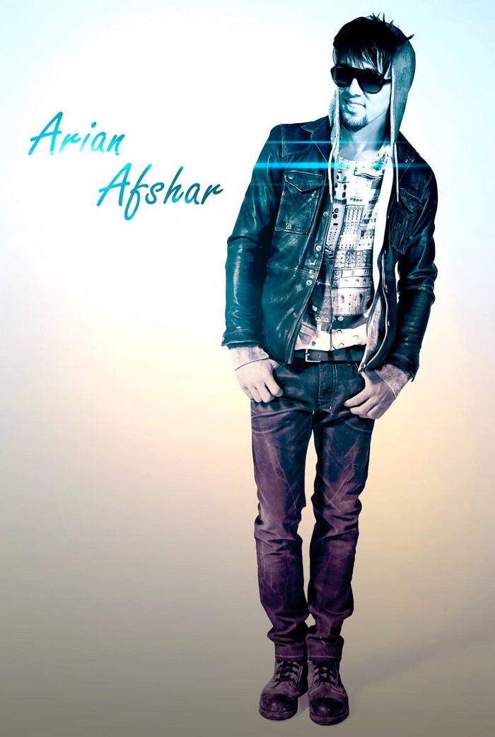 Arian Afshar posing in a leather jacket and jeans
