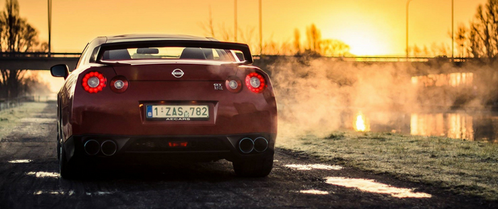 Nissan GT-R sports car at sunset with steam
