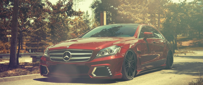 Red Mercedes-Benz E-Class Sedan with custom rims