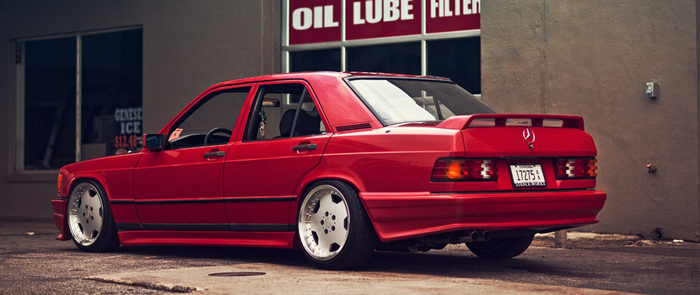 Red Mercedes-Benz 190E W201 with custom wheels