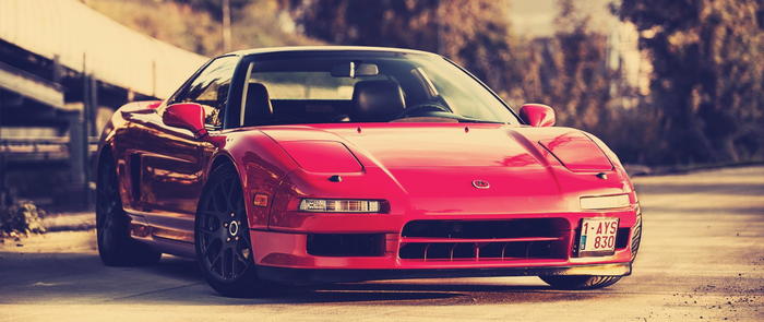 Red Honda NSX sports car with license plate