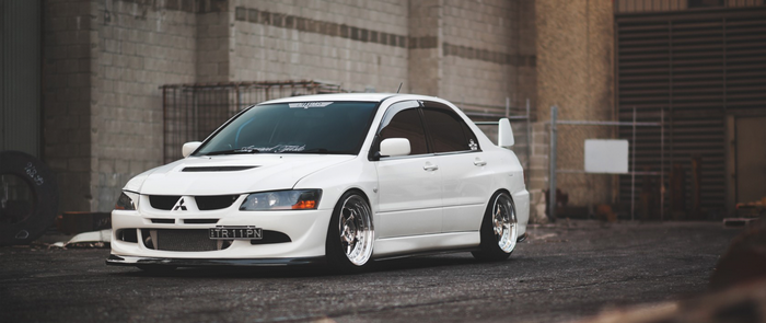 White Mitsubishi Lancer Evolution with custom wheels
