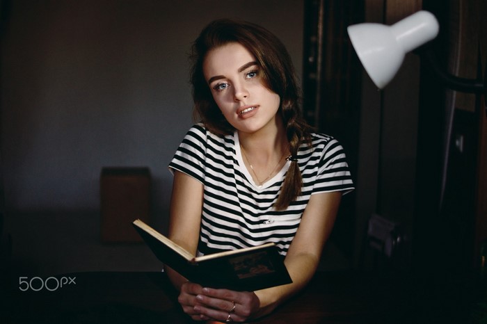 Woman with braids reading a book