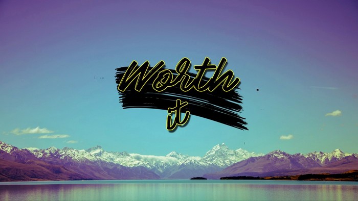 Worth it text over mountains and lake