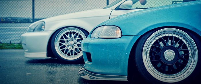 Blue and white Honda Civics with custom rims