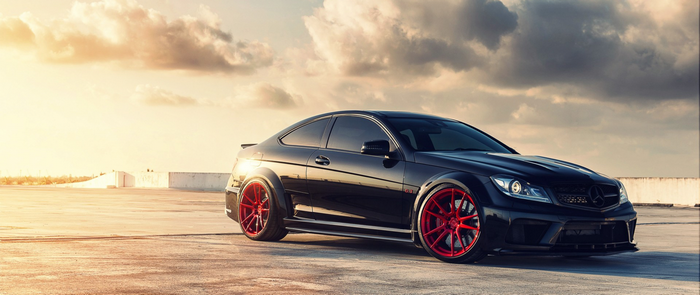 Black Mercedes-Benz C63 AMG Coupe with Red Wheels
