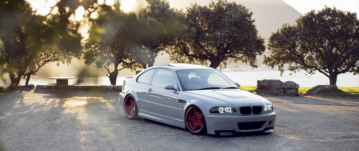 Gray BMW M3 Coupe with Red Wheels by the Lake