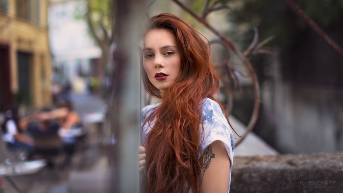 Woman with red hair and tattoo