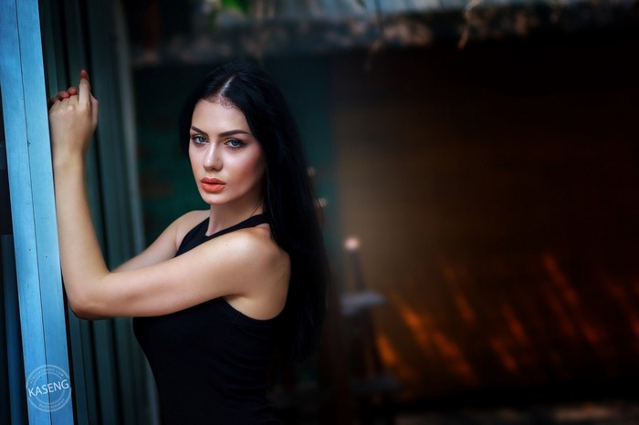 Woman with long black hair and blue eyes