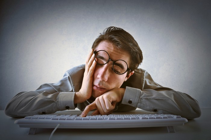 Man in glasses sleeping at a keyboard