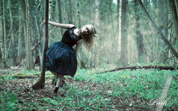 Woman in black dress in a forest