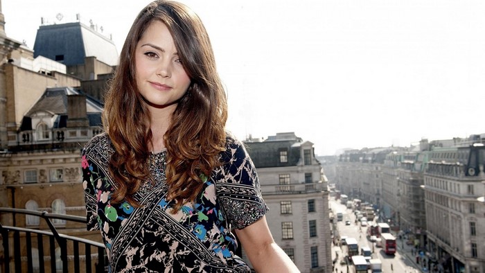 Jenna Louise Coleman on a balcony overlooking a city street