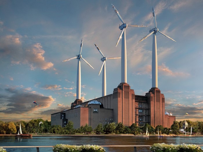Wind turbines atop a brick power station by a river