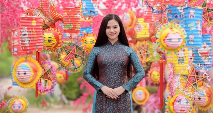 Woman in traditional dress surrounded by lanterns
